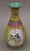 A Chinese yellow ground porcelain vase decorated with figures. 22.5 cm high.