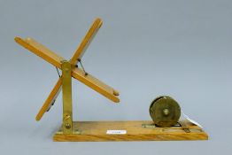 A Hardy's 1911 folding oak line drier with 2 1/2'' Hardy Brass Birmingham style trout reel with