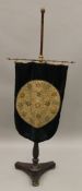 A Victorian embroidered pole screen. 144 cm high.