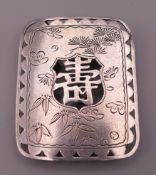 A Japanese silver belt buckle. 4.25 x 3.5 cm.