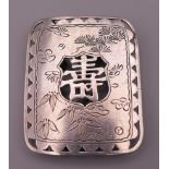 A Japanese silver belt buckle. 4.25 x 3.5 cm.