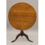 A George III oak tilt top tripod table. 81 cm diameter.