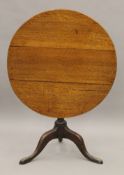 A George III oak tilt top tripod table. 81 cm diameter.