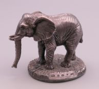 A clad silver model of an elephant. 4.5 cm high.
