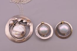 A Modernist unmarked silver mother-of-pearl pendant brooch on a silver necklace and a pair of