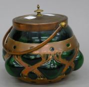 A Cobral Ware copper and green glass biscuit barrel. 20 cm high overall.