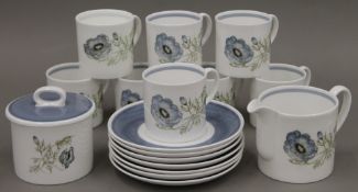 A set of Susie Cooper Glen Mist pattern porcelain coffee cups (8), saucers (7) and a sugar bowl.