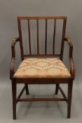 A 19th century mahogany open arm chair. 59 cm wide.