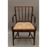 A 19th century mahogany open arm chair. 59 cm wide.