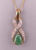 A 9 ct gold emerald and diamond pendant on a 9 ct gold chain. Pendant 1.