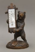 A 19th century carved Blackforest bear form thermometer. 29 cm high.