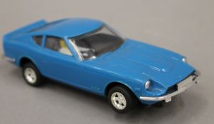 A vintage Scalextric Datsun with remains of original box.