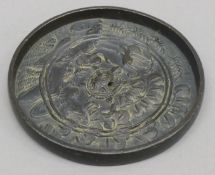 A small Japanese bronze mirror. 11 cm diameter.