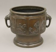 A large 19th century Oriental bronze censor with elephant head handles and panels containing rocky