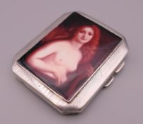 A silver cigarette case decorated with a female nude. 8.5 cm x 7.25 cm. 106.8 grammes total weight.