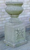 A composition garden urn on pedestal. 94 cm high.