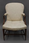A 19th century upholstered open arm chair. 65 cm wide.