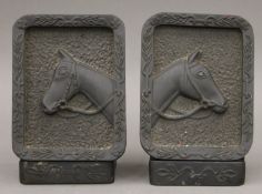 A pair of slate bookends with horse head relief. 17.5 cm high.