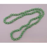 A jade bead necklace. Approximately 72 cm long.