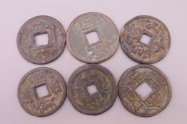 Six Chinese coins. Largest 3.5 cm diameter.