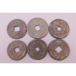 Six Chinese coins. Largest 3.5 cm diameter.