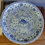 A large Chinese blue and white porcelain charger. 95 cm diameter.