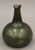 An antique green glass onion shaped bottle. 16.5 cm high.