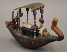 An Egyptian model of a funerary boat. 19 cm long.