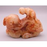 A russet jade model of an elephant and monkey. 8.5 cm long.