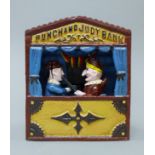 A cast iron Punch and Judy money bank. 18 cm high.