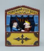 A cast iron Punch and Judy money bank. 18 cm high.