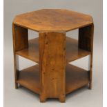 An Art Deco walnut three-tier coffee table. 50 cm wide.