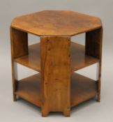 An Art Deco walnut three-tier coffee table. 50 cm wide.