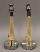 A pair of silver plate mounted deer slot candlesticks. Each 37 cm high.