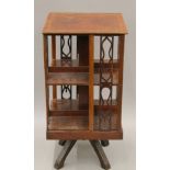 An Edwardian mahogany revolving bookcase. 38 cm square.