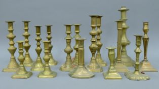 A quantity of 18th/19th century brass candlesticks.