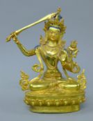 A gilt bronze buddha with sword. 31 cm high.