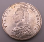 An 1887 silver coin. 3.2 cm diameter.