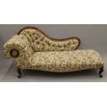 A Victorian upholstered walnut chaise lounge. Approximately 180 cm long.