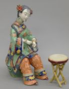 A Shiwan Chinese porcelain figure of a seated woman by Linzhong Dong. 24 cm high.