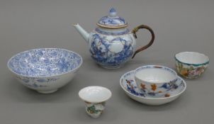 An 18th century Chinese porcelain teapot, a tea bowl and saucer, etc.