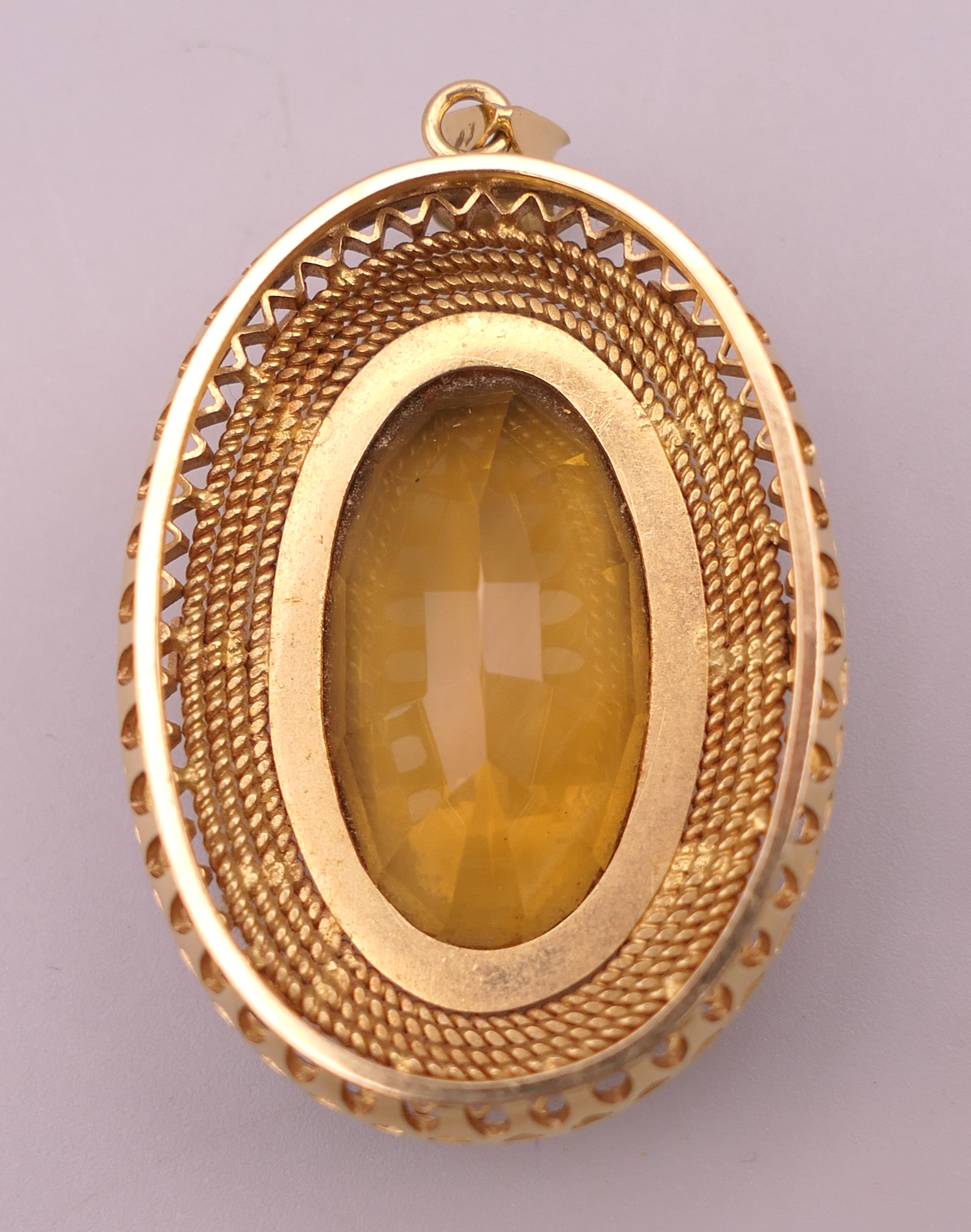 A large unmarked gold citrine pendant (tests as 15 ct plus gold). 5 cm high. 20. - Image 2 of 3
