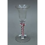 An 18th/19th century etched coloured air twist stem glass. 16 cm high.