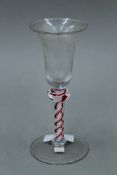 An 18th/19th century etched coloured air twist stem glass. 16 cm high.