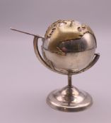 A 925 silver miniature model of a globe. Approximately 7.5 cm high.
