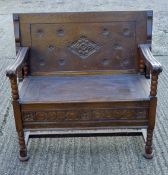 An early 20th century carved oak monk's bench. 99 cm wide.