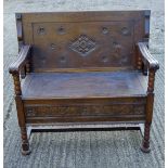 An early 20th century carved oak monk's bench. 99 cm wide.