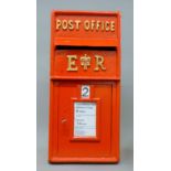 A red post box. 65 cm high.
