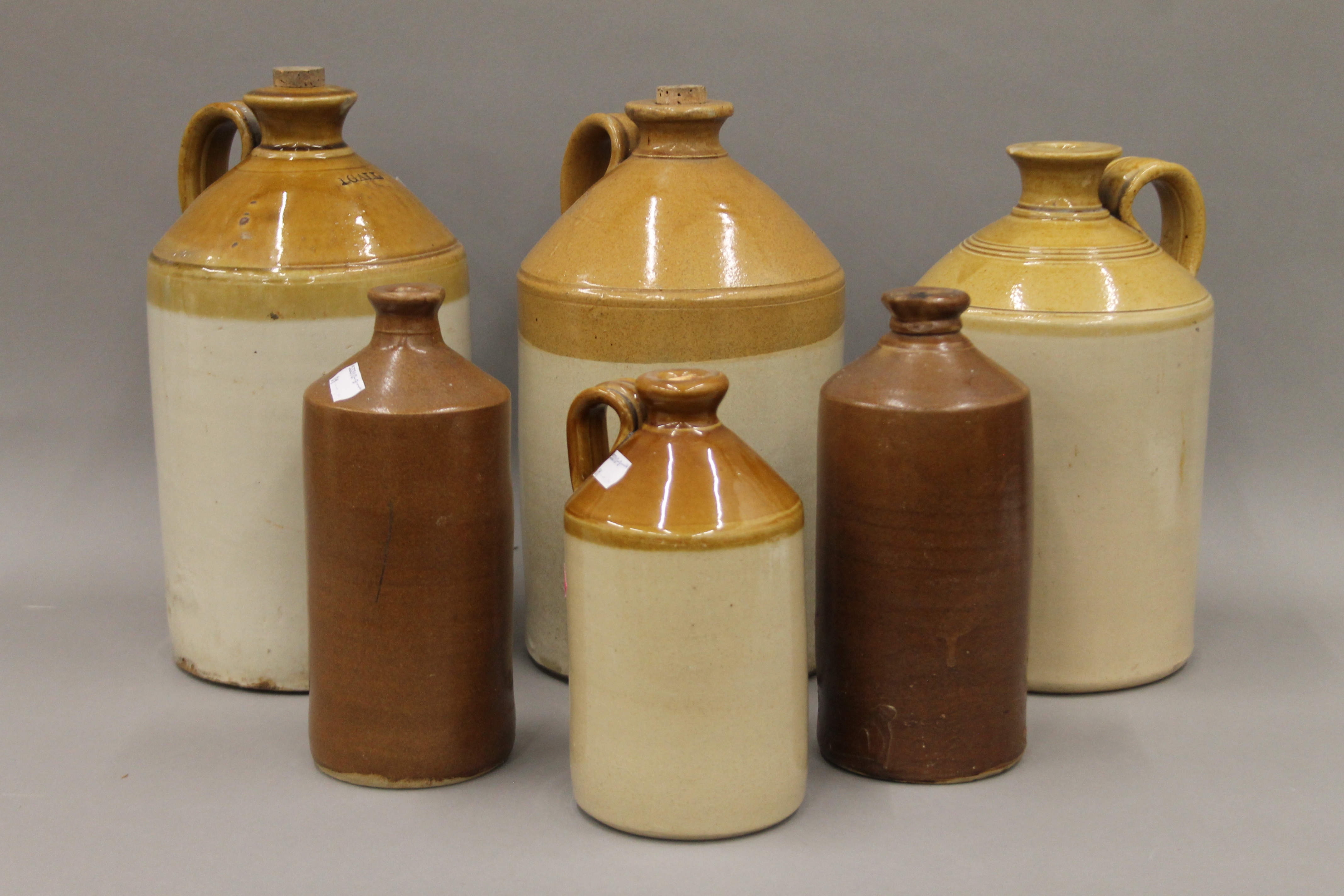 A collection of stoneware flagons. The largest 30 cm high.