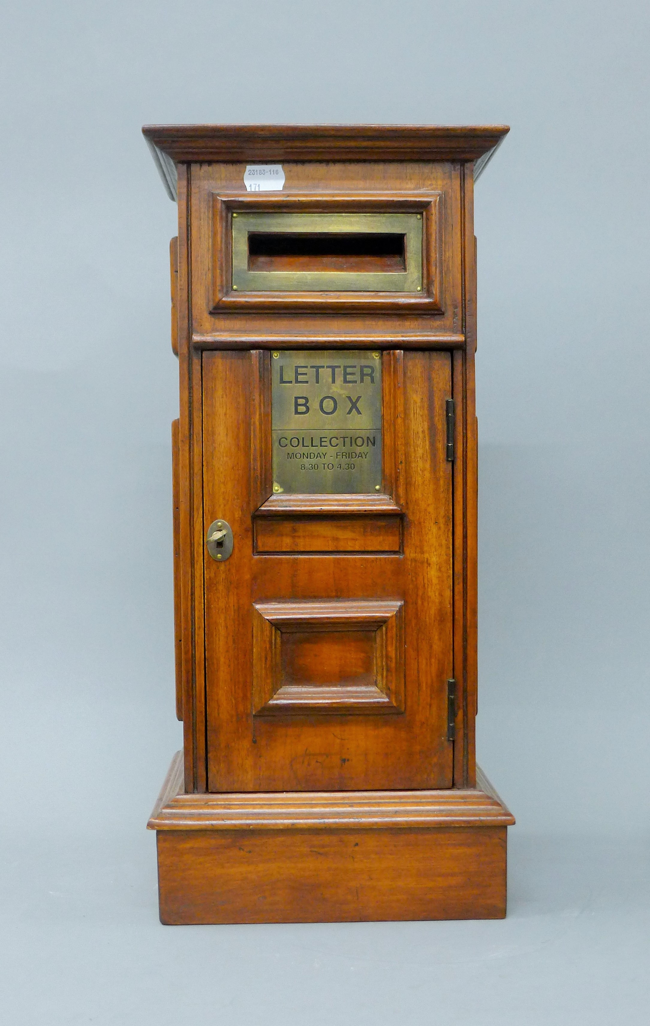 A square wooden post box. 50 cm high.